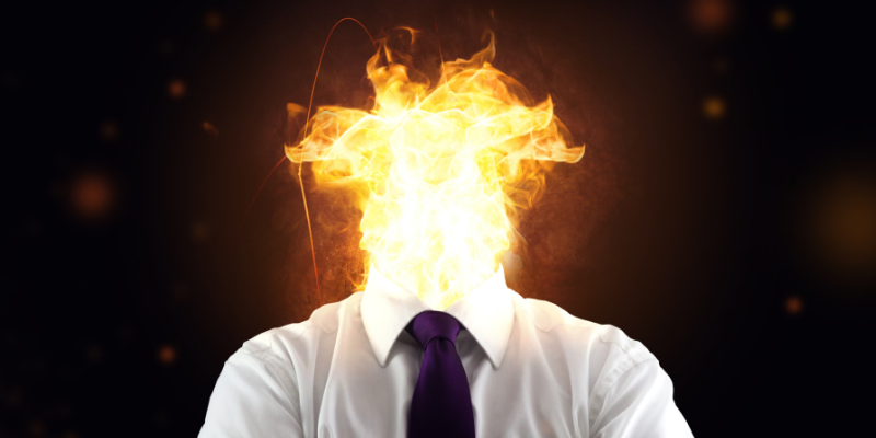 Man in business attire with flames in place where his head was supposed to be