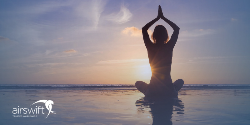 Young woman practicing yoga for meditation and well-being, beach