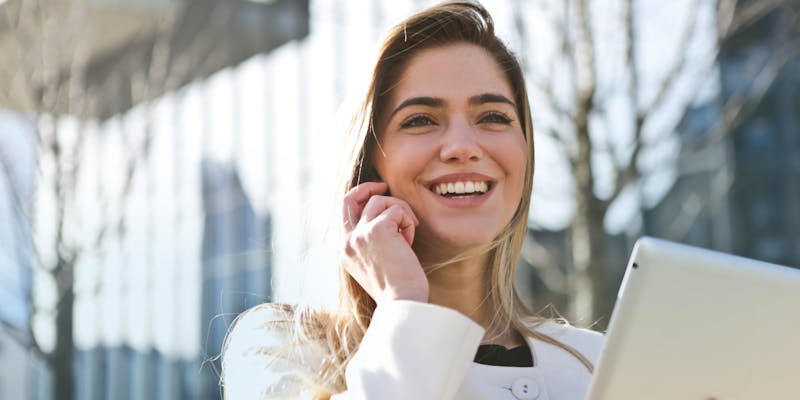 smiling businesswoman outside an office building